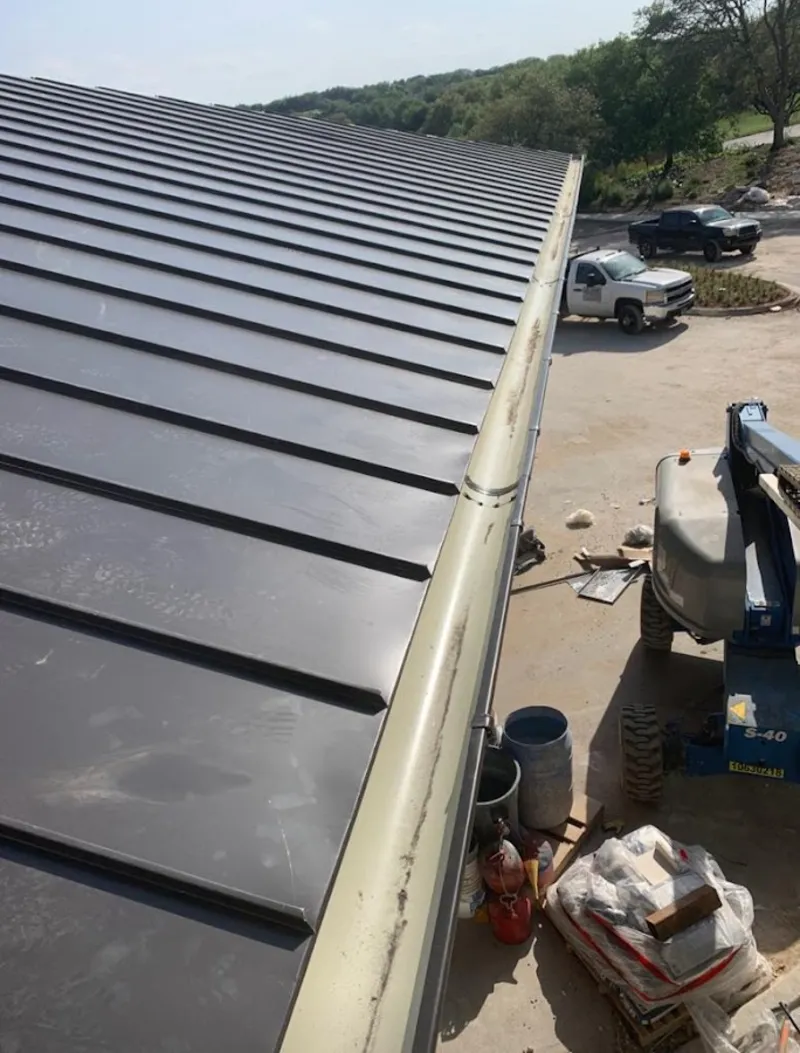 Standing seam panel and gutter detail on a metal roofing jobsite in Corona de Tucson